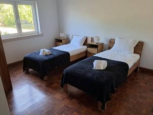 a room with two beds and a window at Quinta dos Choupos in Coimbra