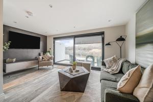 a living room with a couch and a flat screen tv at 3 Bed in Looe oc-j29456 in Looe
