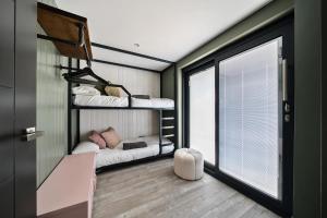 a room with two bunk beds and a window at 3 Bed in Looe oc-j29456 in Looe