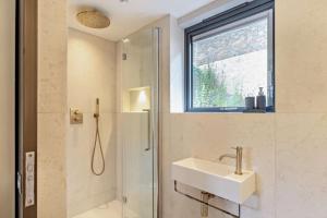 a bathroom with a sink and a shower and a window at 3 Bed in Looe oc-j29456 in Looe +29 photos