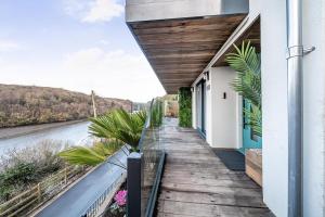 a house with a wooden walkway next to a river at 3 Bed in Looe oc-j29456 in Looe