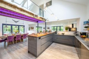 an open kitchen and dining room with purple accents at 4 Bed in Steeple Bumpstead oc-hatch in Steeple Bumpstead