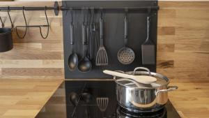 a pot on a stove in a kitchen with utensils at Sesto Senso in Ponte di Legno +49 photos