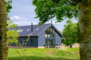 a house with a black roof and windows at 4 Bed in Steeple Bumpstead oc-hatch in Steeple Bumpstead