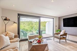 a living room with a large sliding glass door at 3 Bed in Looe oc-a29455 in Looe