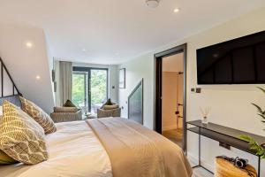 a bedroom with a large bed with a television on the wall at 3 Bed in Looe oc-a29455 in Looe