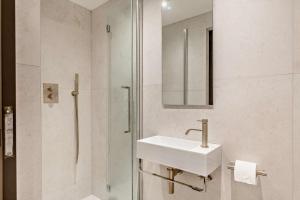 a white bathroom with a sink and a shower at 3 Bed in Looe oc-a29455 in Looe +22 photos