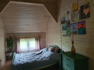 a bedroom with a bed in a room at ojcowska stodoła in Wola Kalinowska