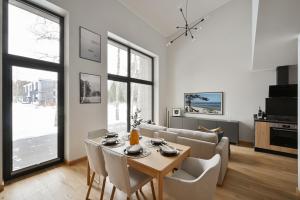 a living room with a table and a couch at Timeout Albatross Resort - Sea, Relax & Design in Ķesterciems