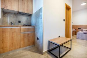 a kitchen with wooden cabinets and a table at Villa Petra in Neum +106 photos