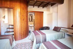 
a hotel room with two beds and a television at Las Casas del Potro in Córdoba
