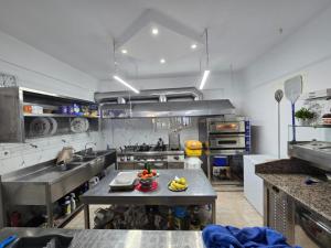 a large kitchen with a table in the middle at Hotel Bar Pizzeria Verona in Ksamil