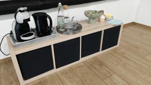 a wooden cabinet with black doors in a room at La Petite Auberge de Graux in Mettet