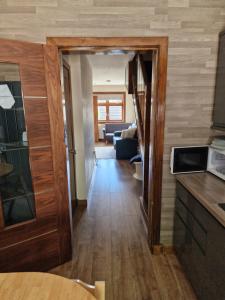 a hallway with a kitchen and a living room at Self-catering extended family home in Edinburgh