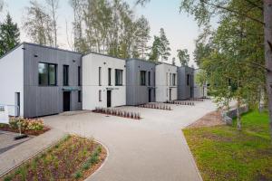 a row of modular buildings in a park at Timeout Albatross Resort - Sea, Relax & Design in Ķesterciems