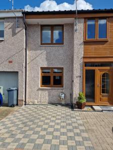 a house with a brick driveway in front of it at Self-catering extended family home in Edinburgh
