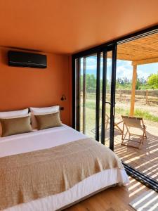 a bedroom with a bed and a sliding glass door at Luz Retreat in Luz de Tavira