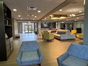a lobby with couches and chairs in a hospital at Holiday Inn Express & Suites Cocoa by IHG in Cocoa