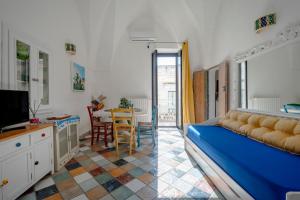 a living room with a blue couch and a table at Domus Magistri in Ostuni