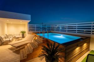 a swimming pool on the roof of a building at Naiades Guest House in Sálakos