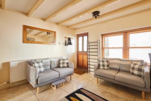 a living room with two couches and a mirror at Host & Stay - Sea Haven in Staithes +24 photos