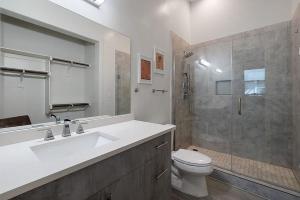 a bathroom with a toilet and a sink and a shower at South Downtown Condo no.308 in Dallas