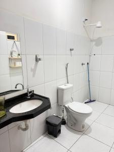 a bathroom with a toilet and a sink at Pousada ExtraLar in Fortaleza +55 photos