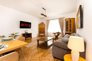 a living room with a couch and a table at The Bucket - Calla Old Town House with Jacuzzi & View in Braşov