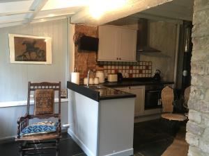 a kitchen with a white island in a room at Cottage Sleeps 4 with Wifi in Llanfairpwllgwyngyll