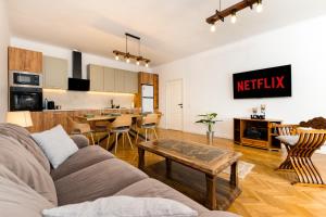 a living room with a couch and a kitchen at The Bucket - Calla Old Town House with Jacuzzi & View in Braşov