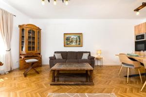 a living room with a couch and a table at The Bucket - Calla Old Town House with Jacuzzi & View in Braşov