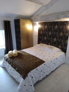 a bedroom with a bed with two towels on it at Chez cococuisine in Les Nouillers