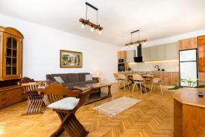 a living room with a couch and a table at The Bucket - Calla Old Town House with Jacuzzi & View in Braşov