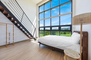 a bedroom with a bed and a large window at Goseung Poolhouse Poolvilla 151 in Goseong