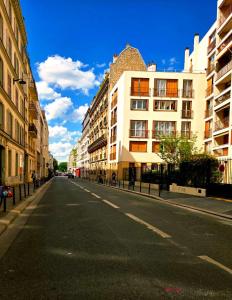 an empty street in a city with buildings at Spacious Studio Paris La villette-Metro in Paris