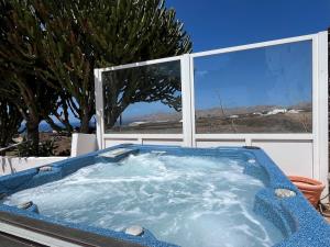 a jacuzzi tub in front of a window at Casa Tara - 5 bedroom, 4 bathroom villa with private pool in Mácher
