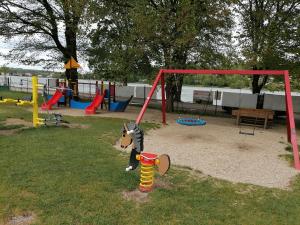a playground with a toy dog standing on a pole at Chata u Kempu in Jedovnice
