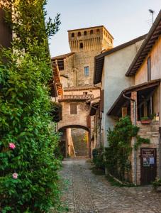 an alley in an italian village with a castle at Forum Guest House FREE Private Parking in Parma