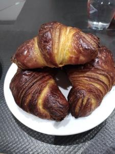 a plate of croissants and pastries on a table at Chez cococuisine in Les Nouillers