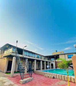 a building with a swimming pool and a staircase next to it at Baba s Villa in Lonavala +7 photos