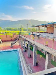 a view of a pool at a resort with a bridge at Baba s Villa in Lonavala