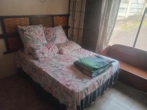 a small bed in a room with a window at Sleep Well in Durban
