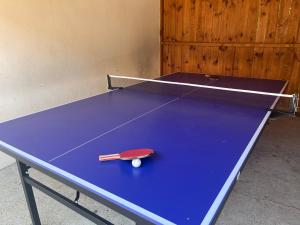 a ping pong table with a ping pong ball on it at Napsugár Apartman in Szaknyér