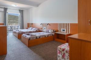 a hotel room with two beds and a balcony at Villa Petra in Neum