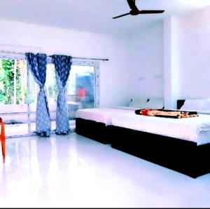 a bedroom with a bed and a window at ANS Green Villa in Yercaud