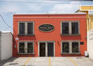a red building with a sign on it at Hotel Andoria in San Salvador +11 photos