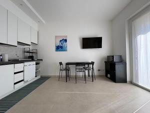 a kitchen with a table and chairs in a room at Blue Iris - Varese - Laghi Svizzera in Varese