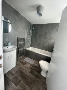 a bathroom with a toilet and a sink at The M Rooms at 144 in Kirk of Shotts