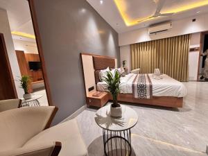 a hotel room with a bed and a table and chairs at Vantara Gir Resort in Sasan Gir