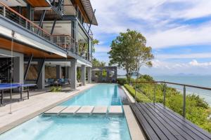 an infinity pool in a house with a view of the ocean at The View in Taling Ngam Beach